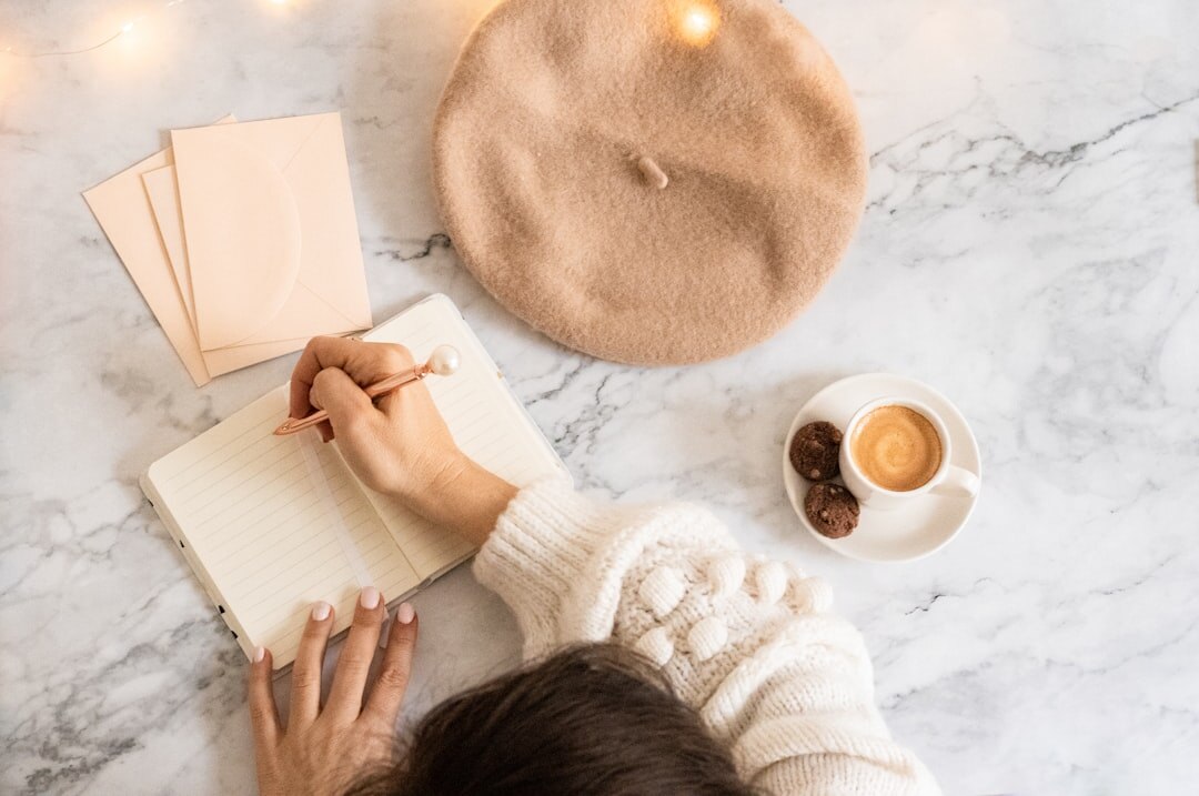 person writing goals in notebook