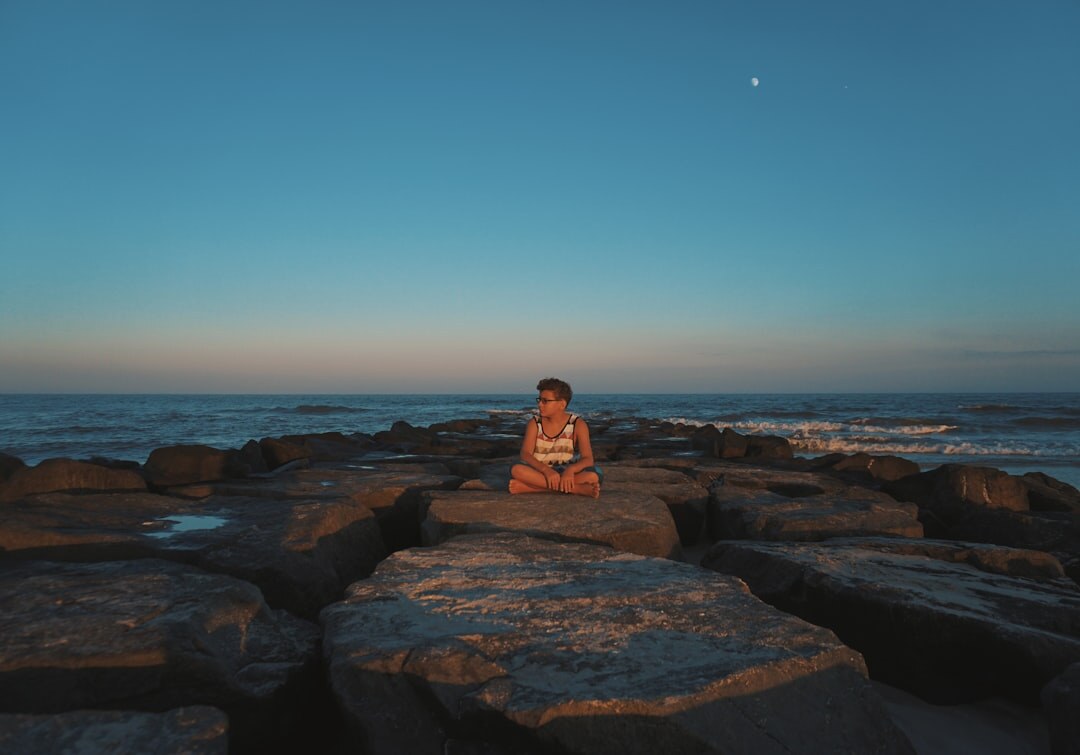 person meditating at sunrise